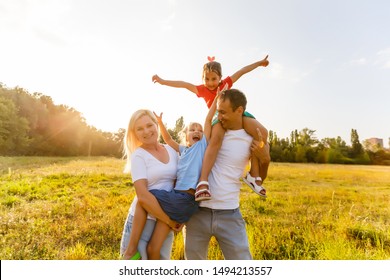 young familiy running through a yellow field