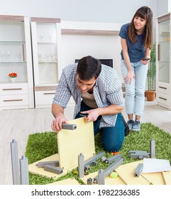 Young Family Assembling Furniture At New House