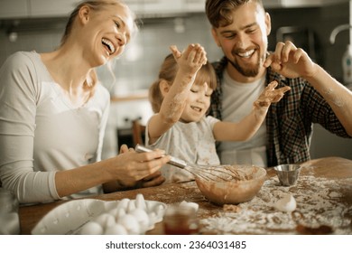 Young family baking together and having fun while being messy in the kitchen - Powered by Shutterstock