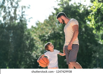 Young Family With A Ball On The Basketball Court