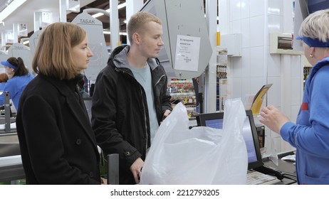 Young Family At The Checkout In The Supermarket, Cashier In The Supermarket. Russia. Tomsk 10.08.2022