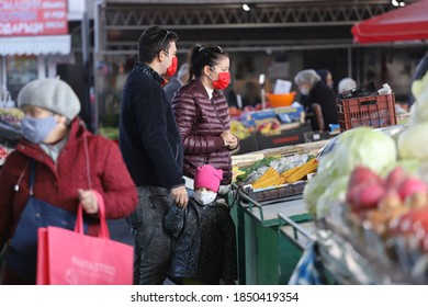 Young Family And Child Are Wearing Face Masks, Are Buying Fresh Fruits And Vegetables On A Farmer Market In Sofia, Bulgaria On Nov 09, 2020