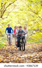 A Young Family With Children On Bicycles