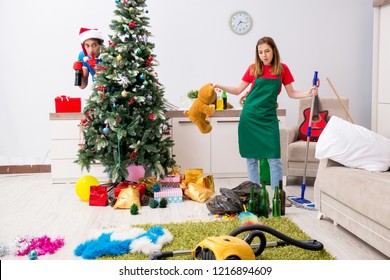 Young Family Cleaning Apartment After Christmas Party