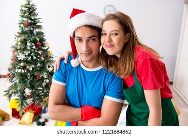 Young Family Cleaning Apartment After Christmas Party