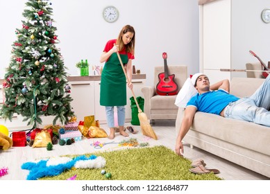 Young Family Cleaning Apartment After Christmas Party