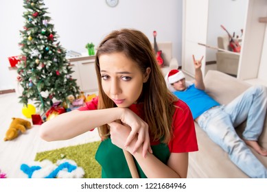 Young Family Cleaning Apartment After Christmas Party