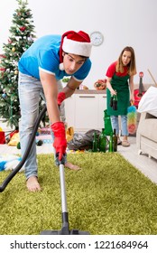 Young Family Cleaning Apartment After Christmas Party