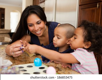 Young Family coloring easter eggs in Kitchen
