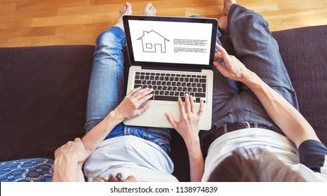 Young Family Couple Choosing New Home Online, Search Real Estate To Buy Or Rent, House For Sale On Screen Of Computer