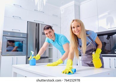 Young Family Couple Doing Cleaning In The House.