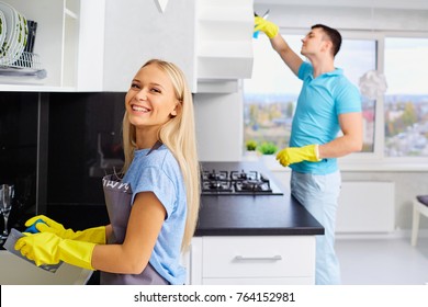 Young Family Couple Doing Cleaning In The House.