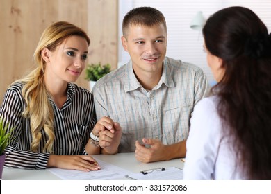 Young Family Couple Trying To Get Loan At Bank Clerk Office. Husband And Wife Asking Social Service Officer For Child Adoption Permission. Planning Future, Married Life, Expectation, Mortgage Concept