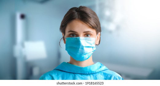 Young Family Doctor Or Veterinarian Nurse Wearing Hygienic Face Surgical Mask In Hospital. Banner Panorama With Blur Modern Clinic In Background.