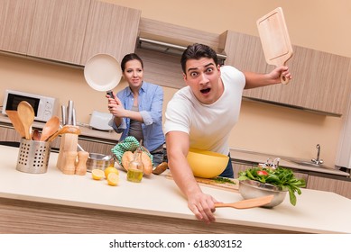 Young Family Doing Funny Fight At Kitchen