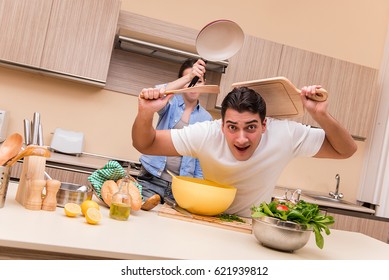 Young Family Doing Funny Fight At Kitchen