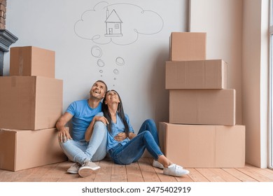 Young family with dreaming about moving into new house. Break, couple and happy in new home with boxes for moving in, satisfied and confident with ownership. - Powered by Shutterstock