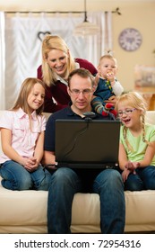 Young Family In Front Of Computer With Camera Having A Video Chat