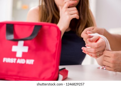 Young Family Getting Treatment With First Aid Kit