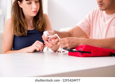 Young Family Getting Treatment With First Aid Kit