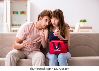 Young Family Getting Treatment With First Aid Kit