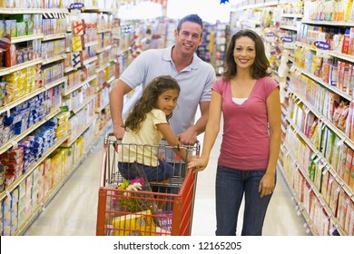 Young Family Grocery Shopping In Supermarket