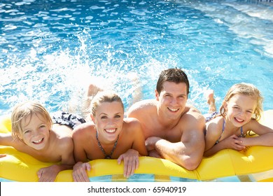 Young Family Having Fun Together In Pool