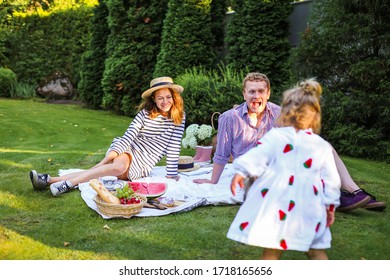 Young family with kid havingfun at  picnic in summer in the park - Powered by Shutterstock