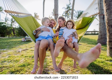 Young family with little kids enjoying their holiday in exotic country, lying in hammock. - Powered by Shutterstock