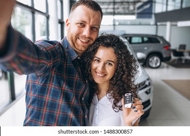 Young Family Making Selfie In A Car Show Room