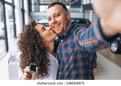 Young Family Making Selfie In A Car Show Room