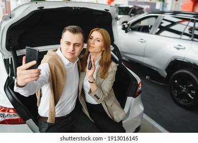 Young Family Making Selfie In A Car Show Room