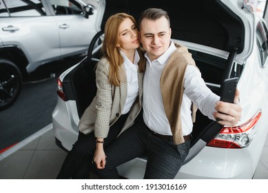 Young Family Making Selfie In A Car Show Room