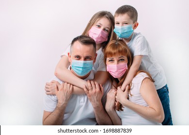 young family in medical masks during home quarantine - Powered by Shutterstock