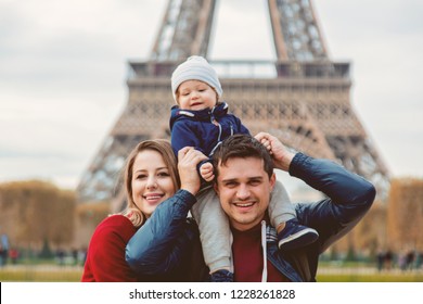 Young Family, Mother, Father And Baby Boy In Paris With Eiffel Tower On Background. Travel Theme Image