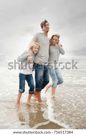 Young family on beach in autumn