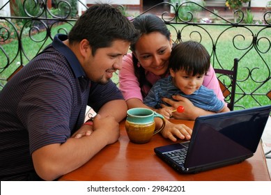 Young Family On The Computer Together