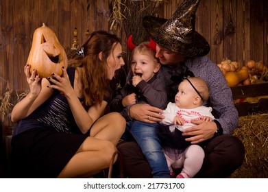 Young Family On Halloween Party With Children 