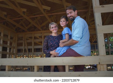 Young family on site inside new ecology wooden home construction framing.