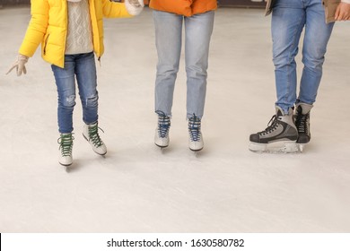 Young Family On Skating Rink