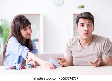 Young Family Playing Cards At Home