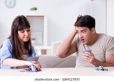 Young Family Playing Cards At Home