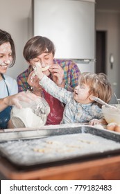 Young Family Playing Flour At Messy Kitchen While Baking