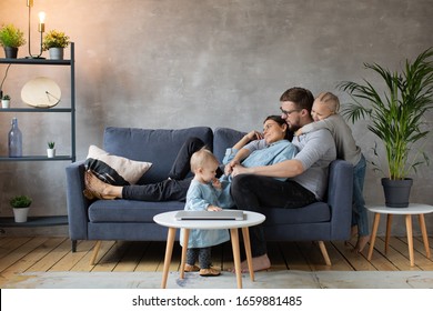 Young Family Playing Together On The Sofa. Happy Family. Home Comfort.