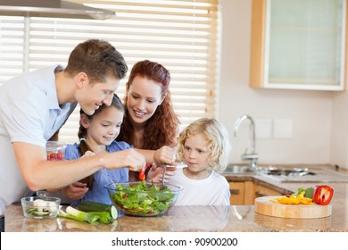 Young Family Preparing Salad Together