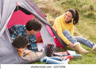 Young Family Relaxing Inside Tent On Camping Holiday