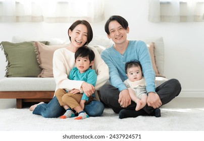 Young family relaxing in the living room - Powered by Shutterstock