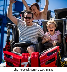 Young Family Screaming With Arms Raised On Roller Coaster In Florida, USA Taken On 2 April 2014