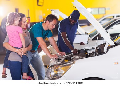 Young Family Taking Their Car For Repair In Garage