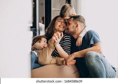 Young Family With Their Sons At Home Having Fun